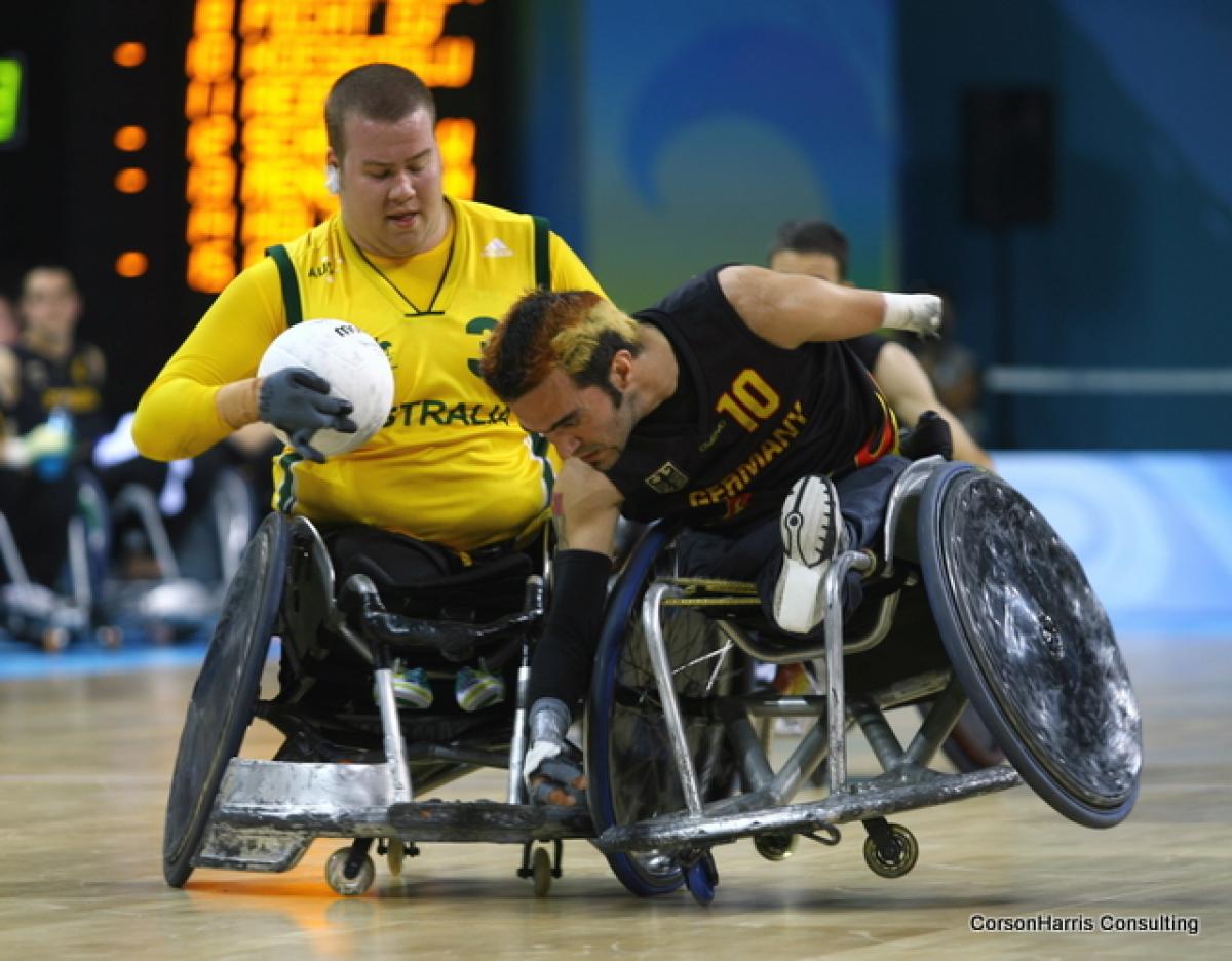 A picture of 2 Wheelchair Rugby players.