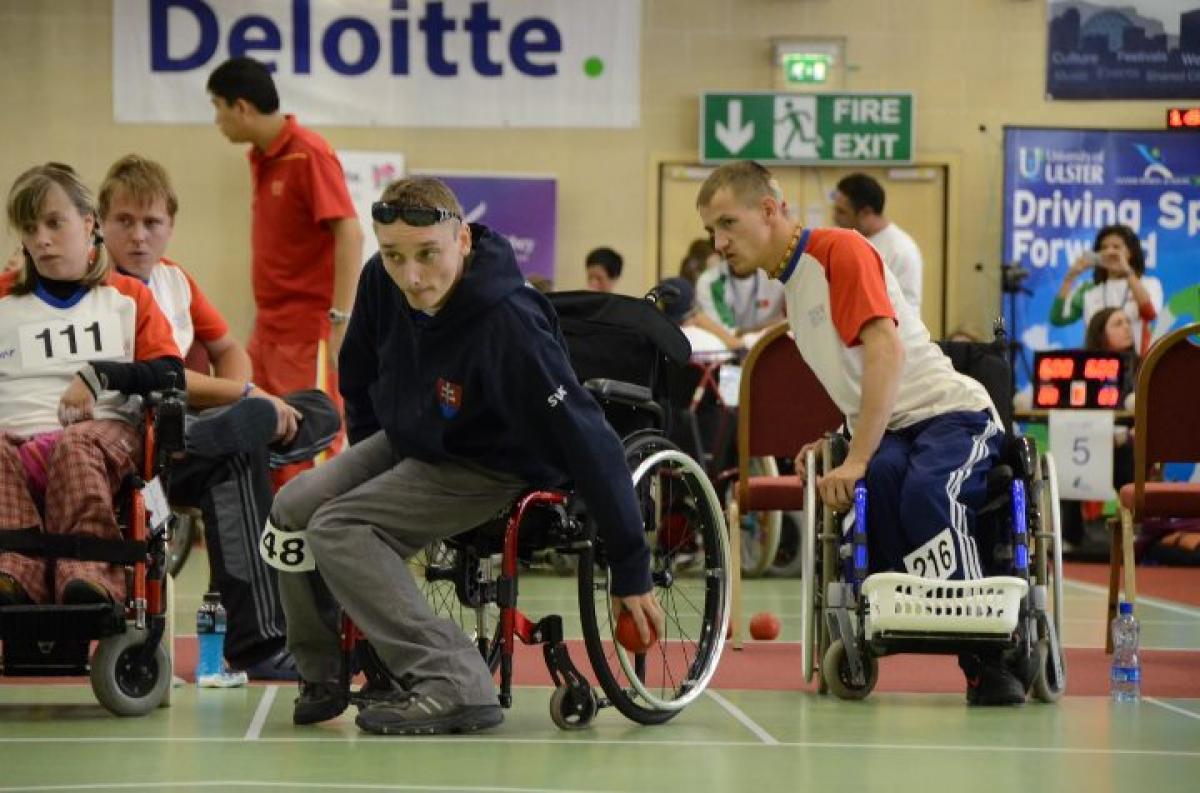 A picture of a man in a wheelchair throwing a small ball