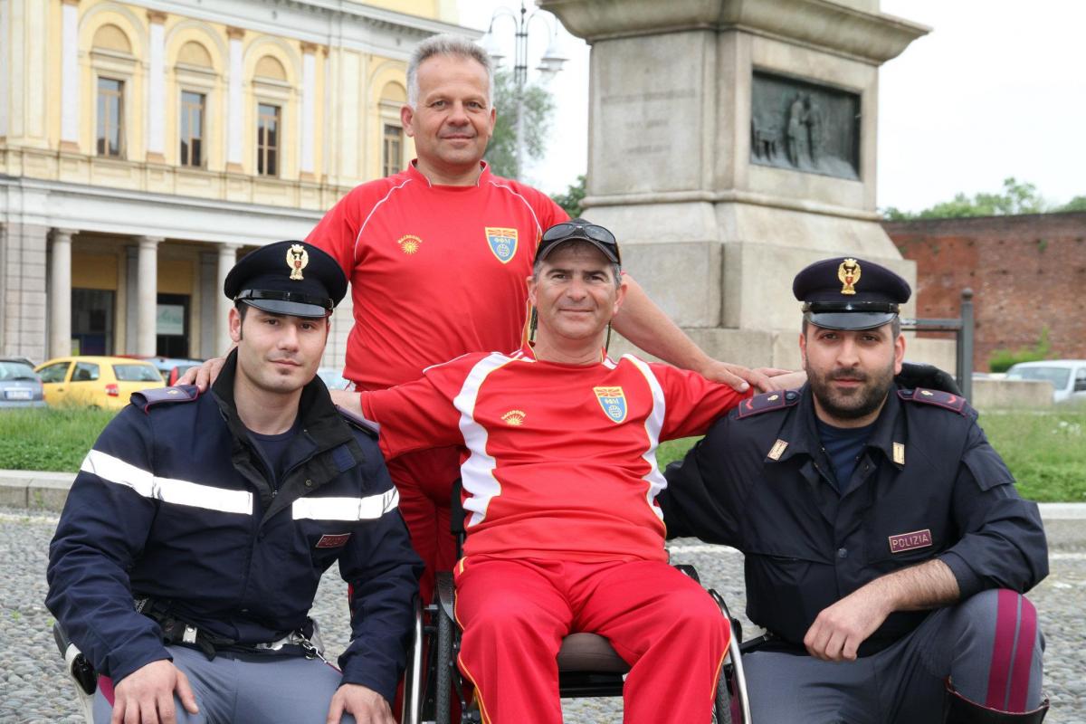 Mile Stojkoski A picture of a man in a wheelchair posing between 2 policemen