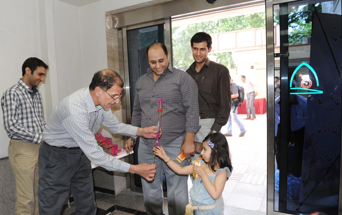 A picture of a man giving a flower to a young lady