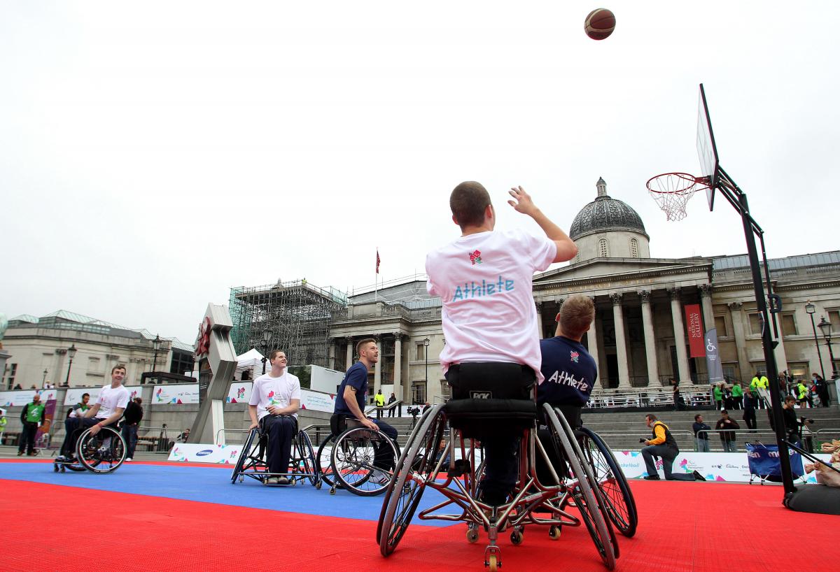 A picture of a man in a wheelchair playing Basketball