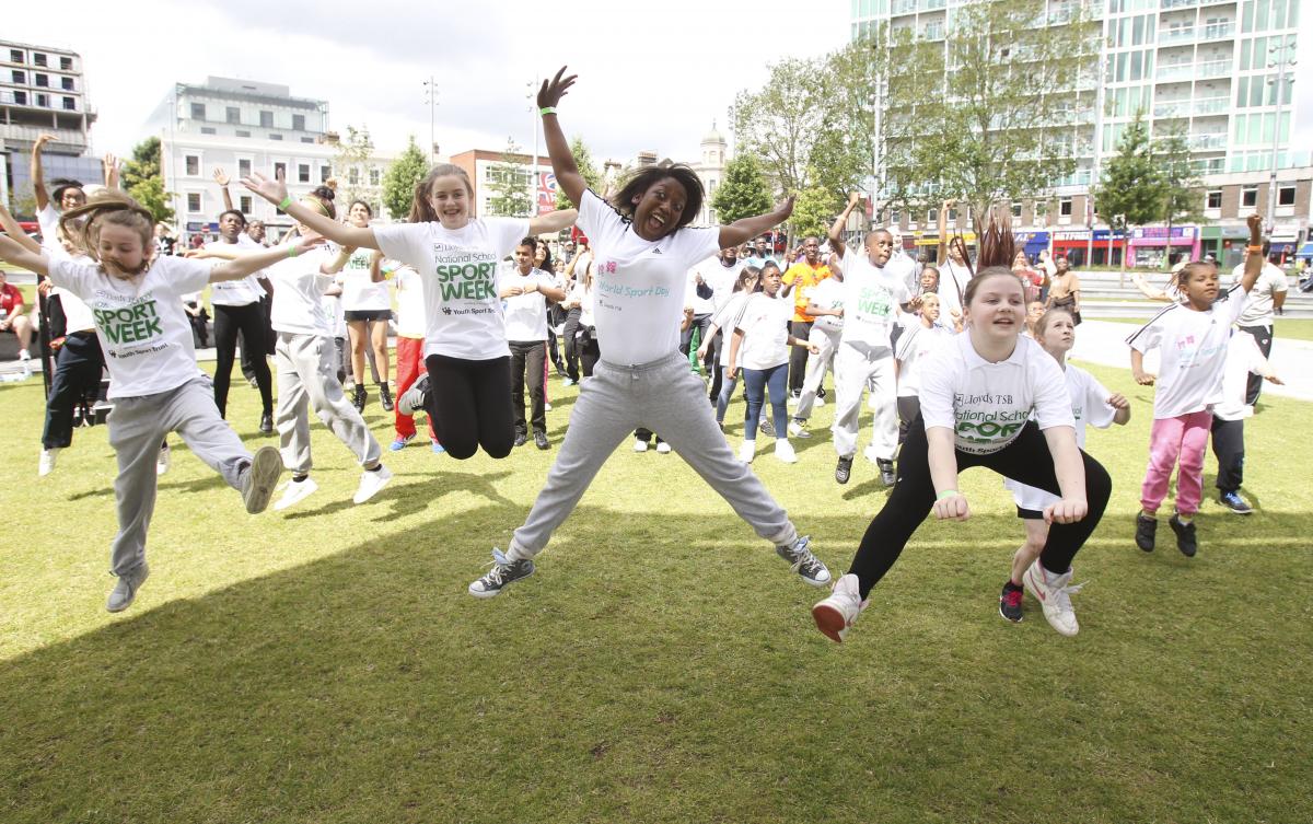 A picture of children jumping in a group picture