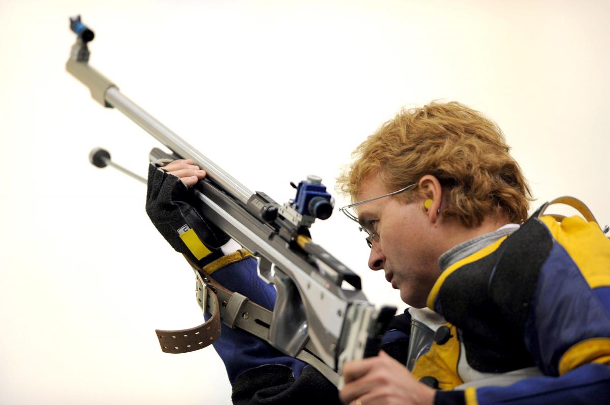 Jonas Jacobsson competing in the Mixed R6-50m A picture of a man holding a gun