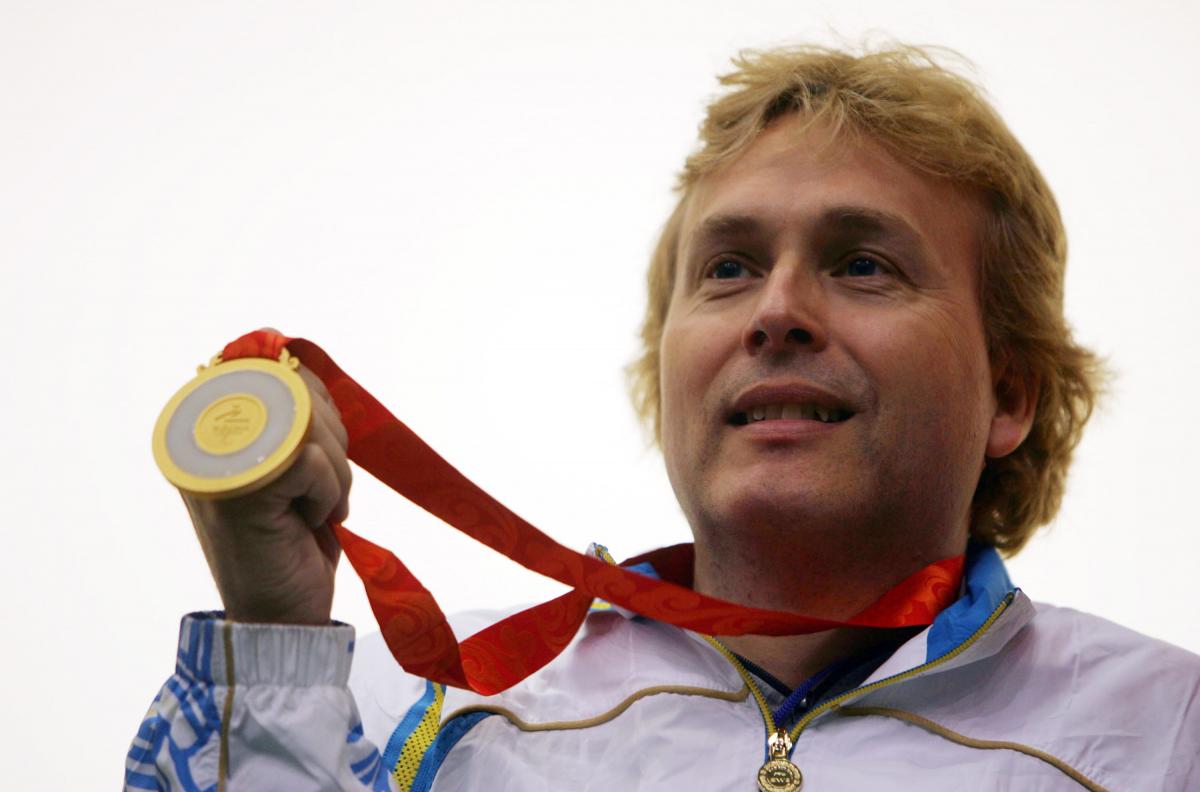 Jonas Jacobsson won the gold medal in the Mixed R6-50m Free Rifle Prone-SH1 Final Shooting competition during day six of the Beijing 2008 Paralympic Games. A picture of man showing his gold medal