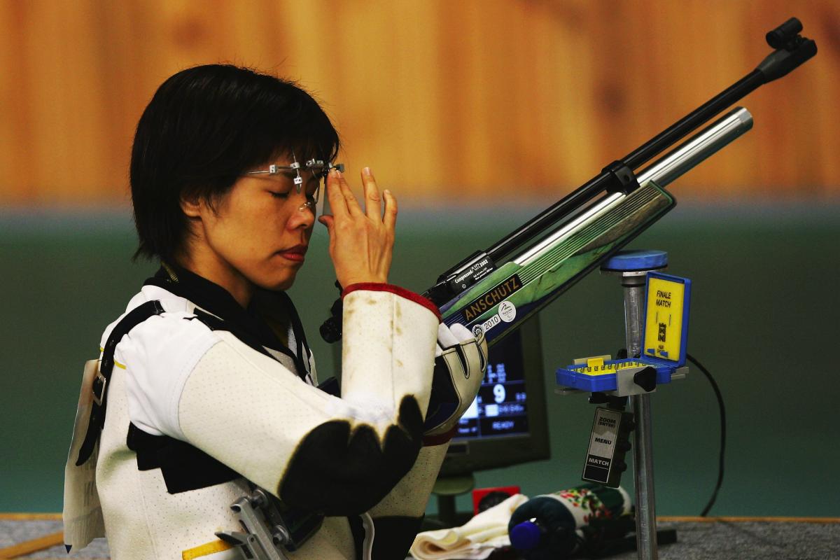 Izumi Takehi from Japan competes in the Women's R2-10M Air Rifle Standing SH1 qualification at the Beijing Shooting Range Hall on September 7, 2008 in Beijing, China. A picture of a girl holding a gun