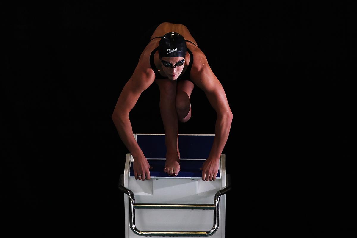 A picture of a woman jumping in a pool