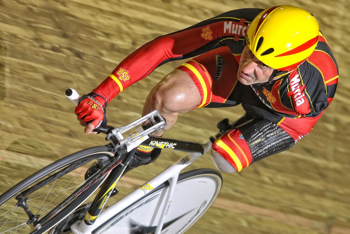 A picture of an amputee man cycling