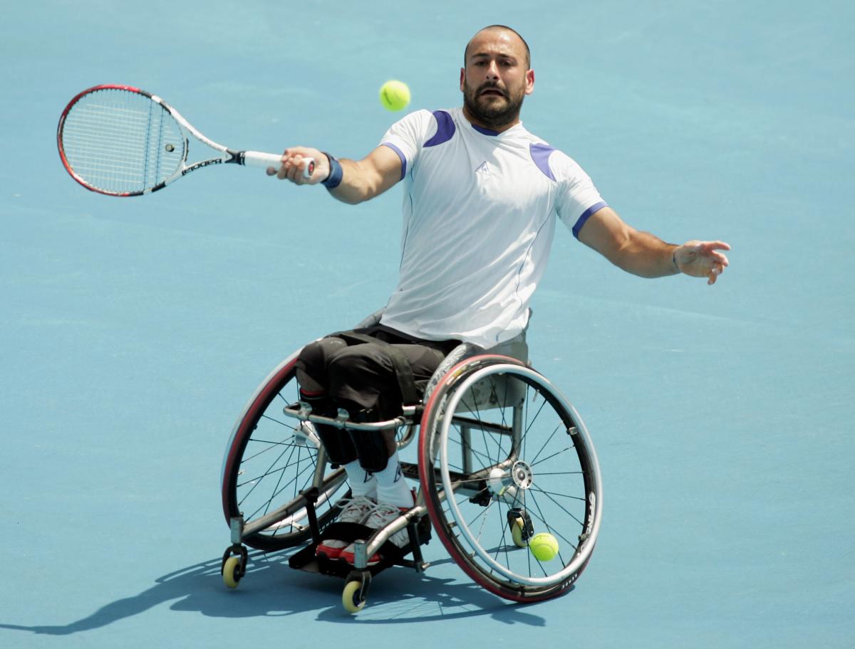 A picture of man in a wheelchair playing tennis