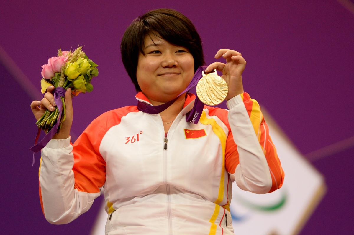 Zhang Cuiping celebrates with her gold medal Zhang Cuiping celebrates with her gold medal
