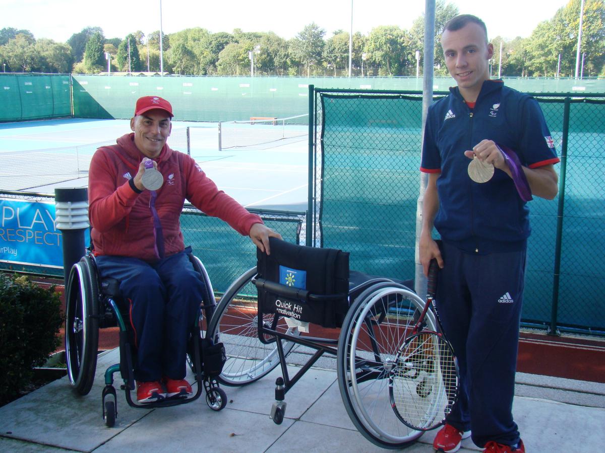 A picture of 2 men showing their medals