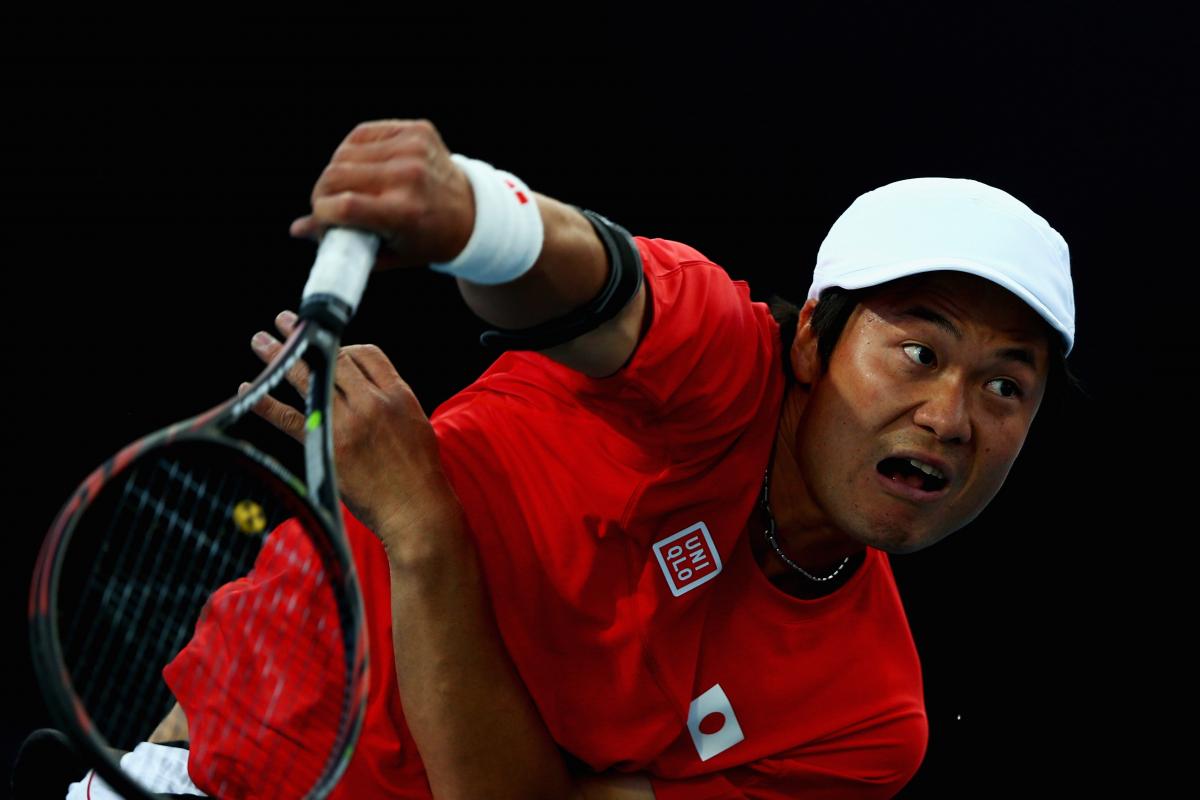 A picture of a man in a wheelchair playing tennis