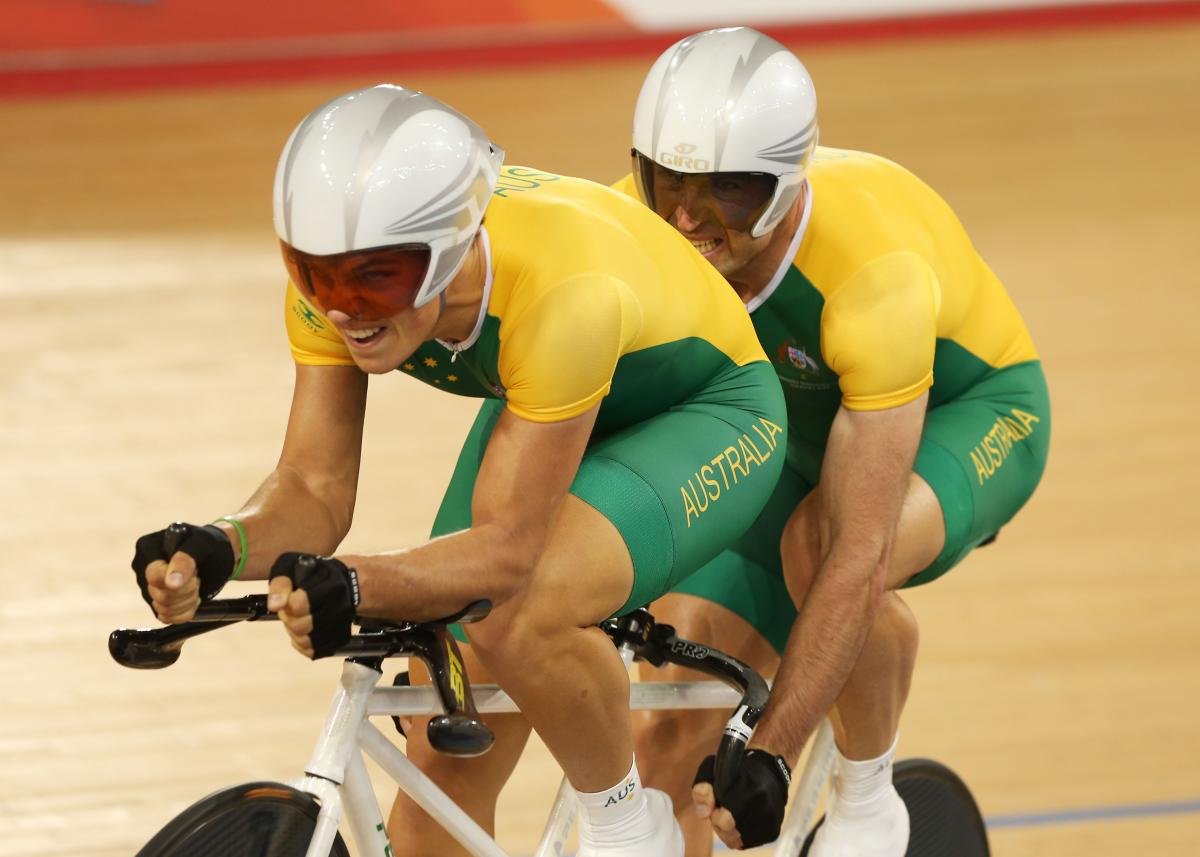 A picture of a two man cycling wit the same bicycle