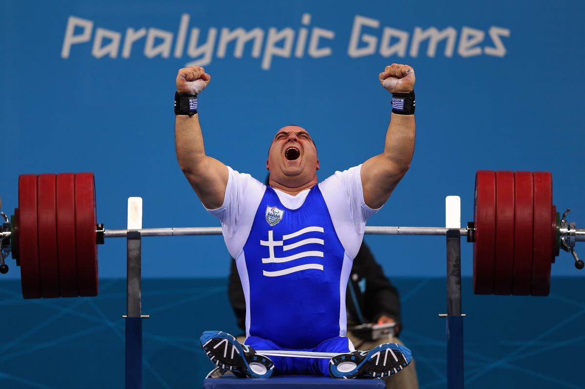 Pavlos Mamalos of Greece reacts with intense joy as he competes in the Men's -90 kg Powerlifting event.