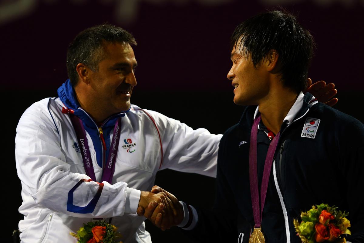 Stephane Houdet and Shingo Kunieda A picture of two men in a wheelchair shaking their hands