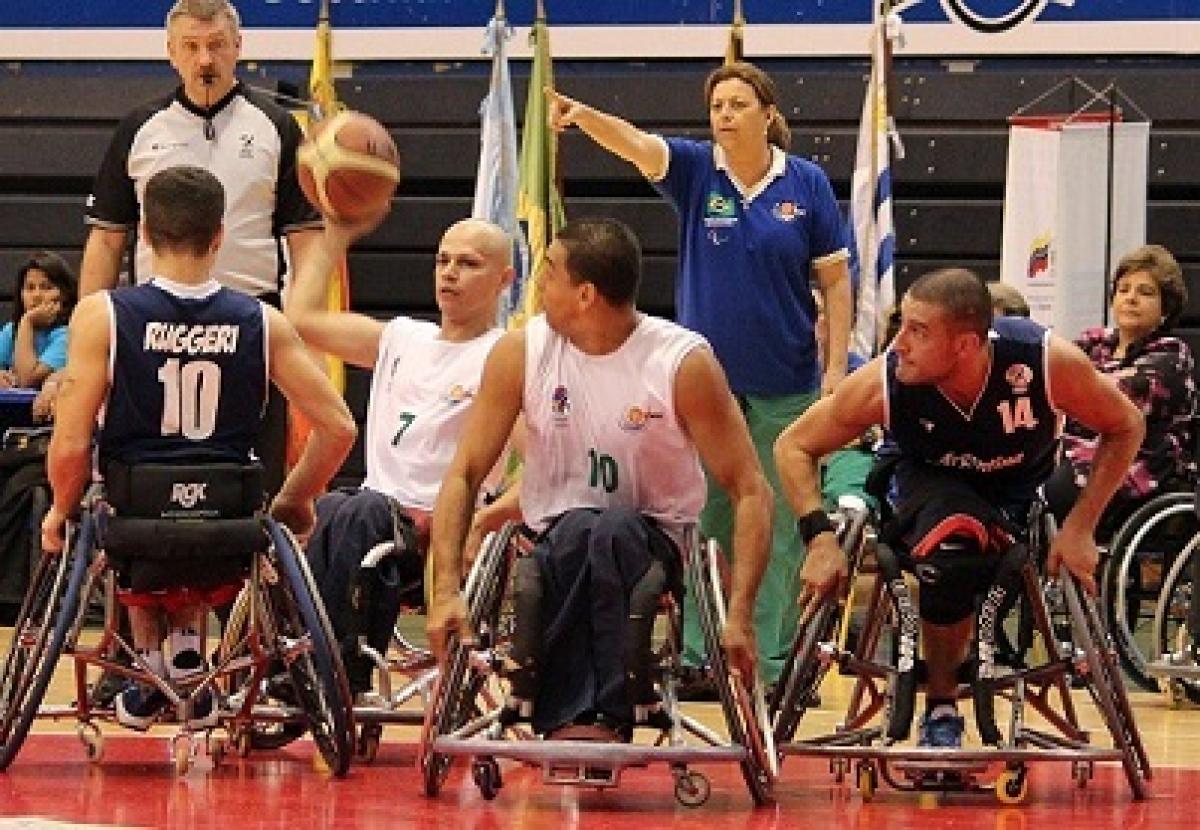 A picture of men in wheelchair playing basketball