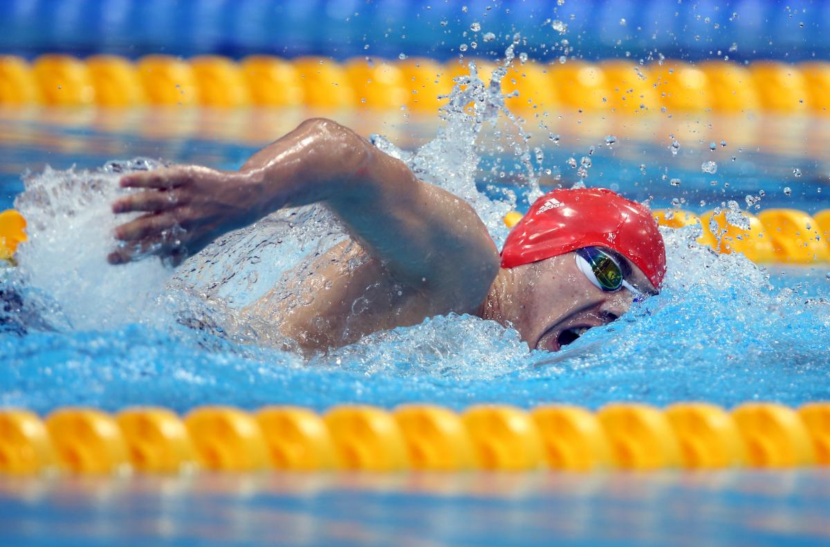 A picture of a man with the swimming cap in the pool