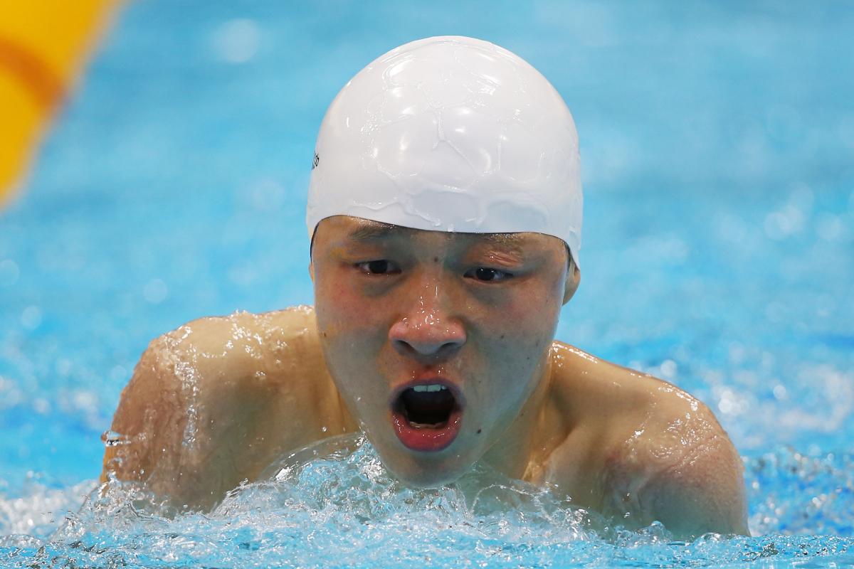 A picture of a man in the pool holding his head above the water