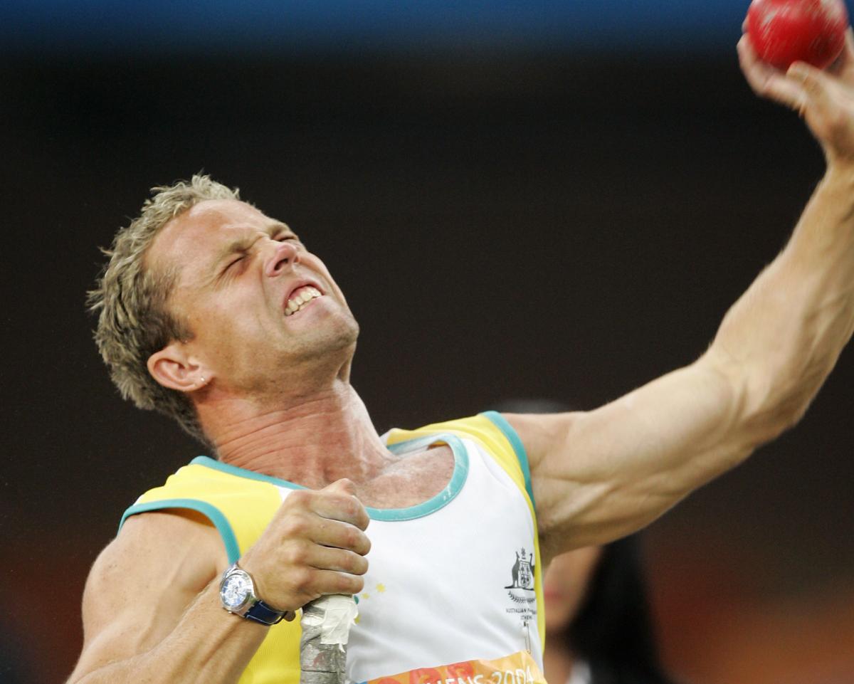 A picture of a man shooting a small ball with his arm