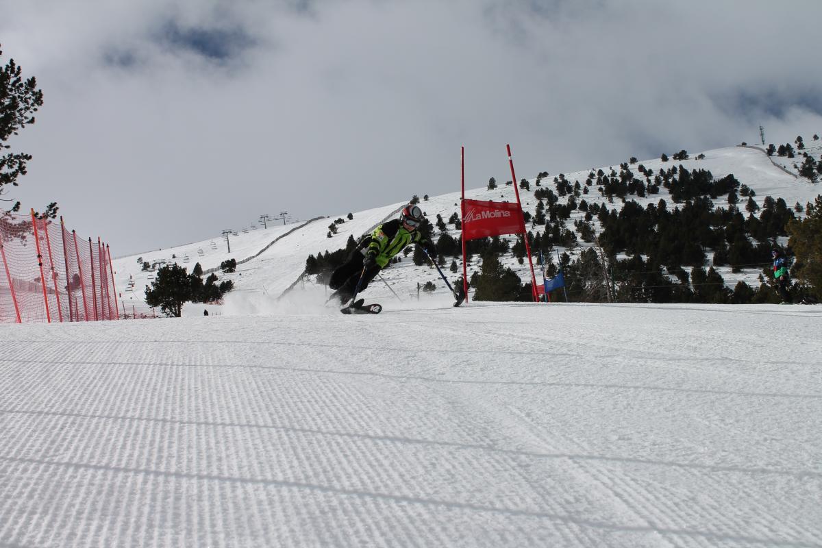 A picture of a woman in a sledge practising snowboard