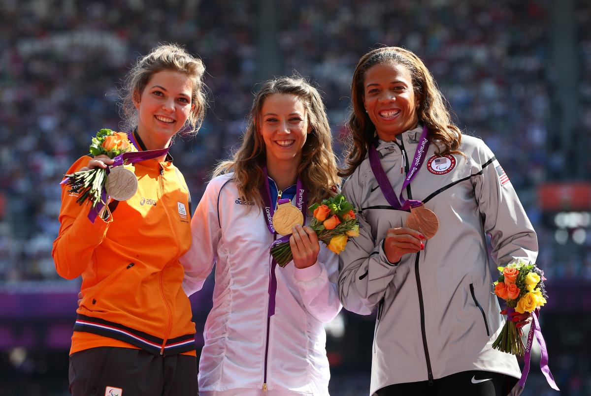 A picture of women on a podium with medals around their neck