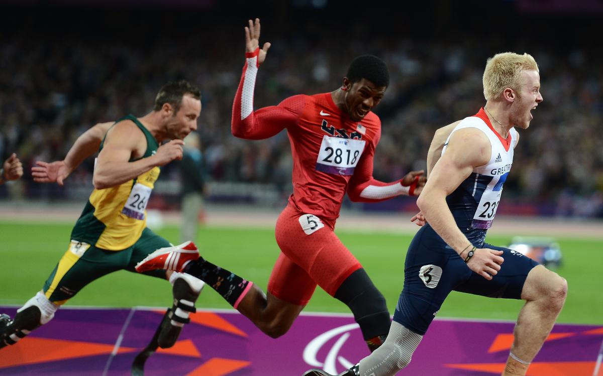 A picture of men running through a finishing line