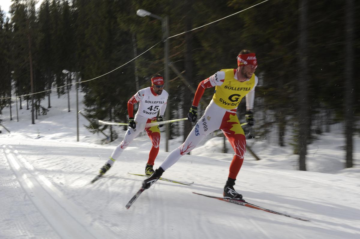 A picture of men skiing on a track