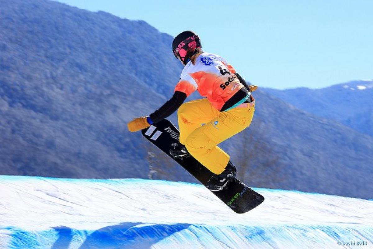 A picture of a woman doing snowboarding.