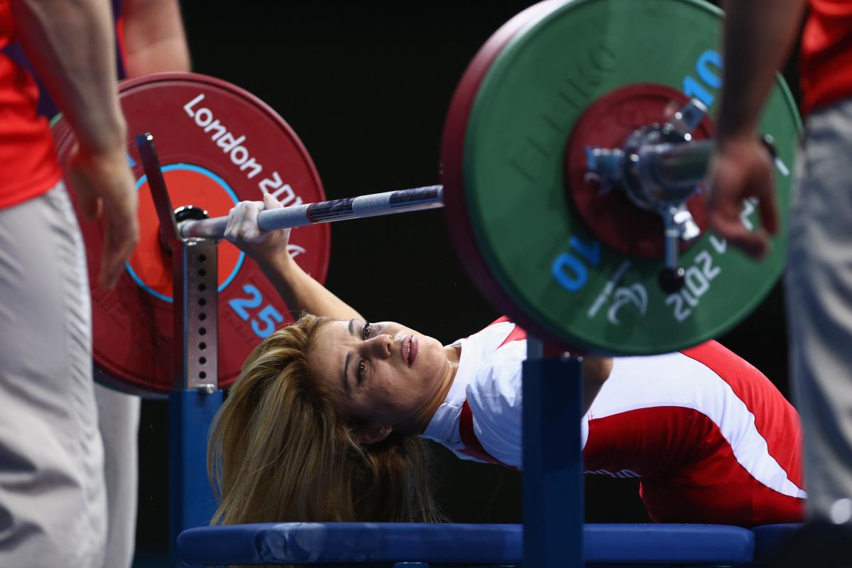 A picture of a powerlifter on a bench competing