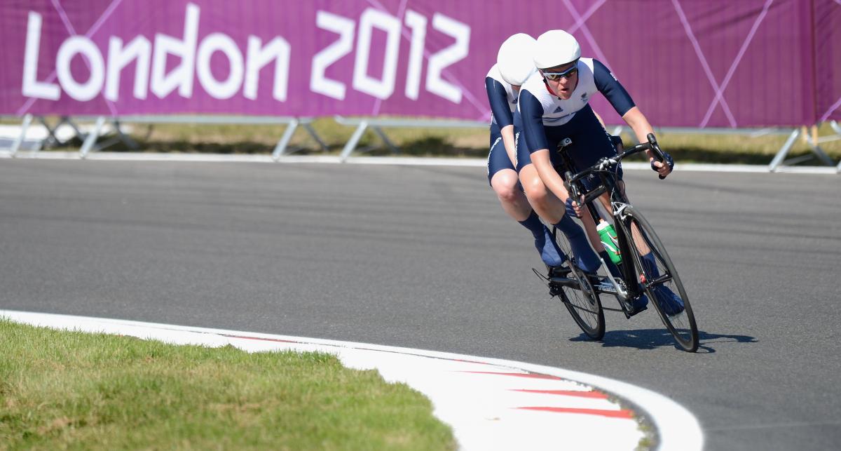 Lora Turnham at the London 2012 Paralympics Women on a bike, cycling on a road outside
