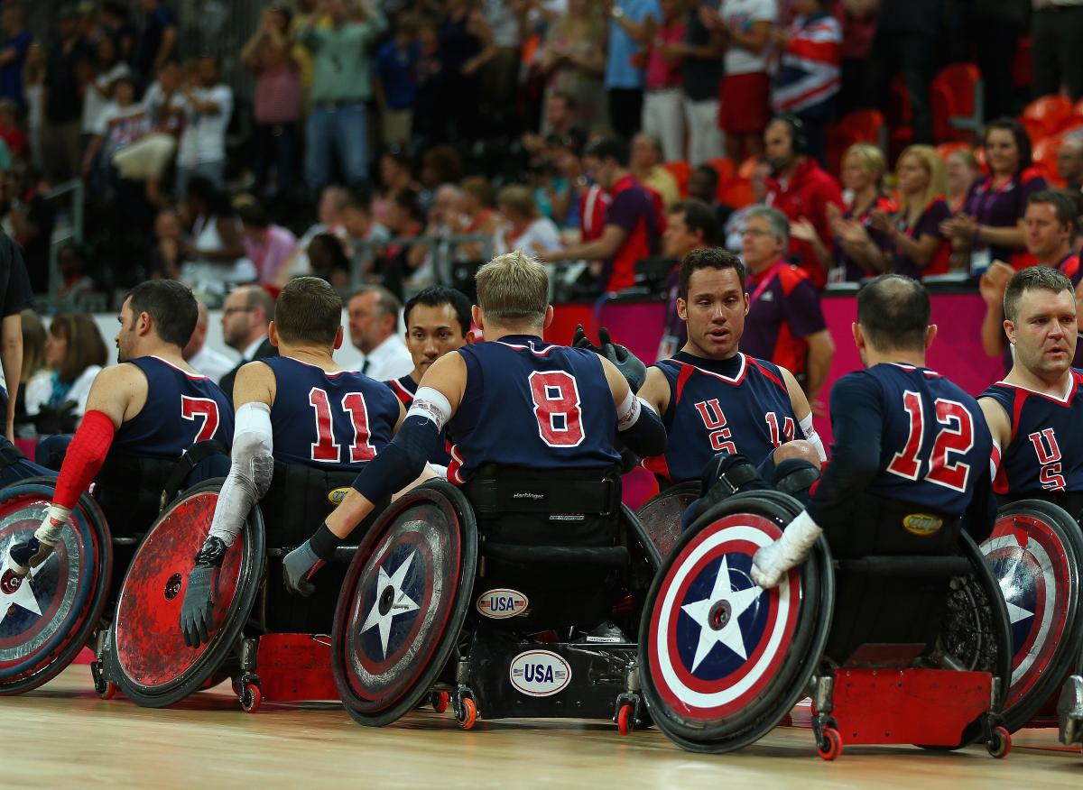 Players in wheelchairs lining up and high five