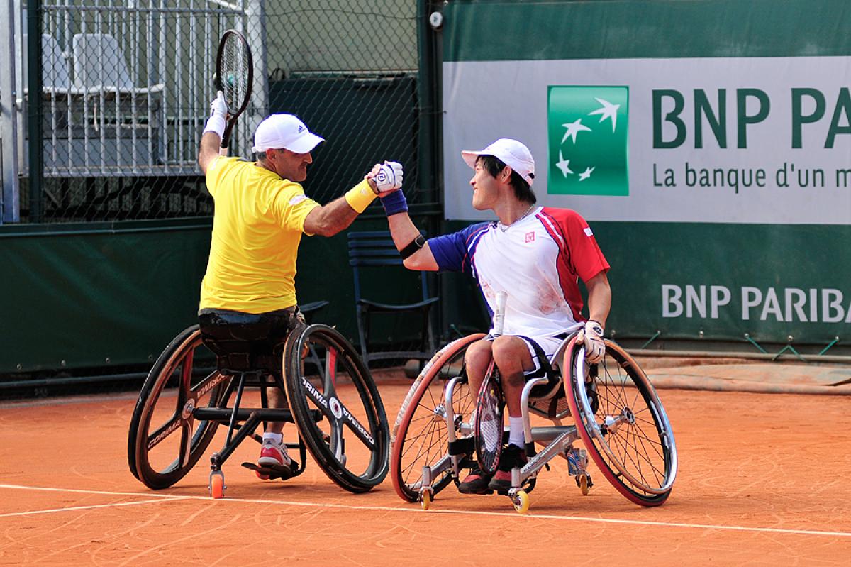 France's Stephane Houdet, left, defeated Shingo Kunieda for the 2013 Roland Garros men's singles titles, and just hours later partnered with him to win the doubles title. 