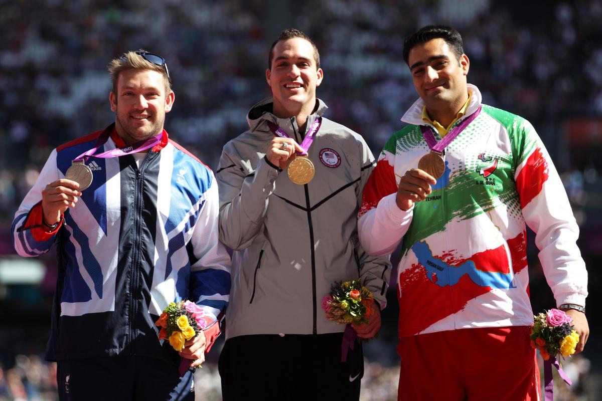 Dan Greaves, Jeremy Campbell and Farzad Sepahvand pose on the podium during the medal ceremony for the Men's Discus Throw F44 final at the London 2012 Paralympic Games