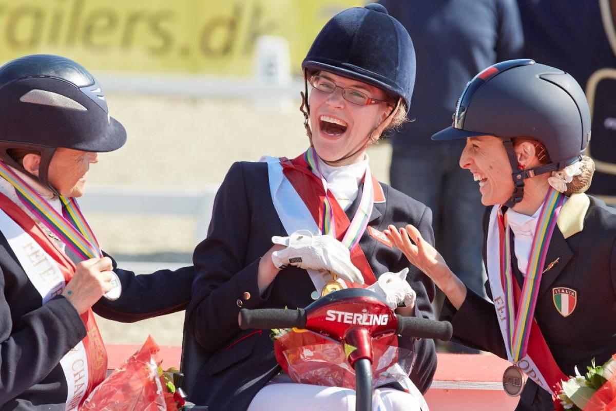Grade 1a Freestyle podium Para-Dressage Euros in Herning 2013 Grade 1a Freestyle gold medallist Sophie Christiansen (GBR), celebrating with compatriot Anne Dunham who took silver and bronze medallist Sara Morganti (ITA), at the JYSK FEI European Para-Dressage Championships in Herning (DEN).