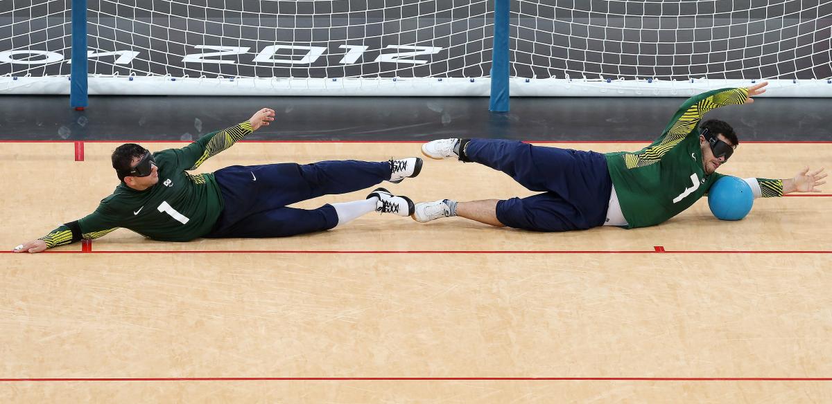 Brazilian Goalball team at the London 2012 Paralympic Games Jose Roberto Ferreira de Oliveira (L) and Filippe Santos Silvestre of Brazil dive in front of the goal during the Men's Group A Goalball match between Finland and Brazil on day 1 of the London 2012 Paralympic Games