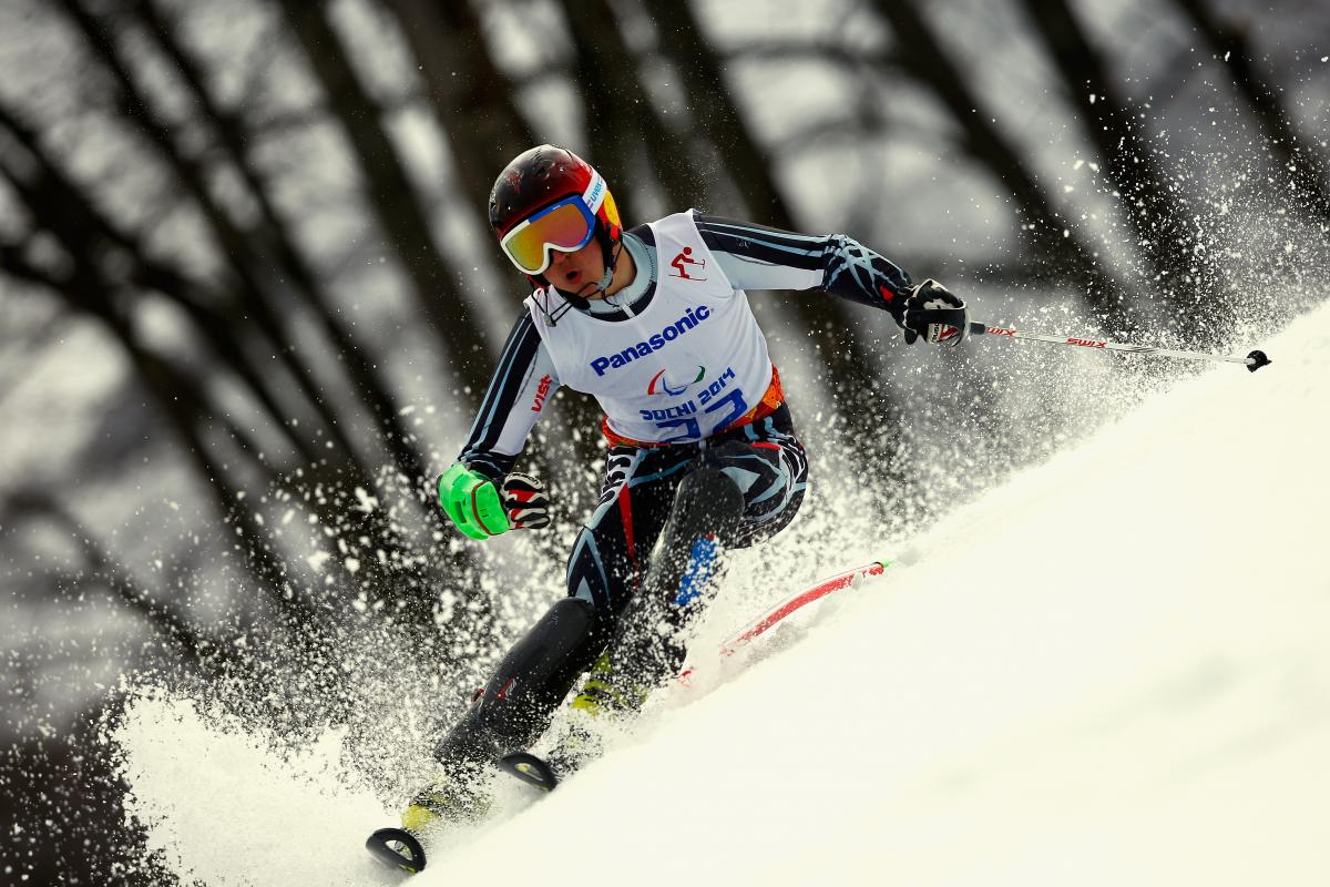 Alexey Bugaev passes a slalom pole in a race in a tilted position