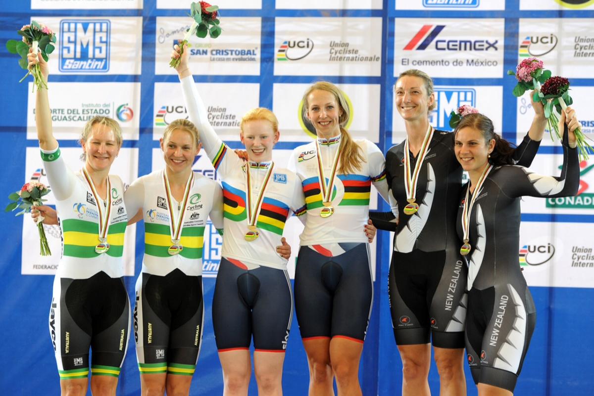 Sophie Thornhill and pilot Rachel James in their rainbow tops stand top of the podium after victory in Mexico
