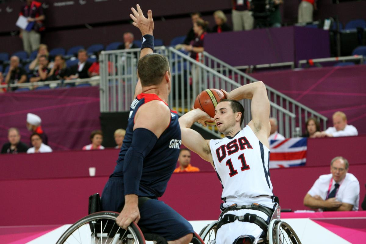 American wheelchair basketball player Steve Serio looks to pass the ball to a teammate.
