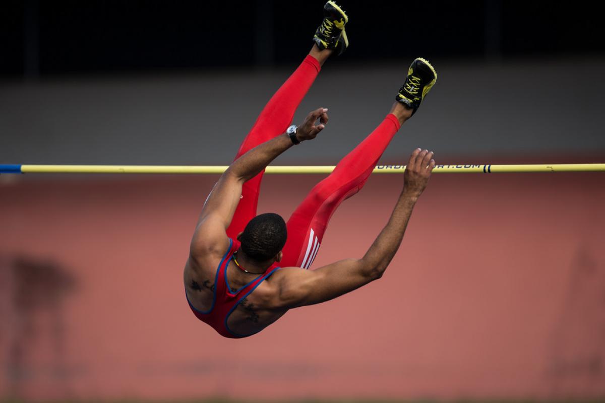 The back of Luis Felipe Gutierrez Rivero is seen as he jumps over the high bar.