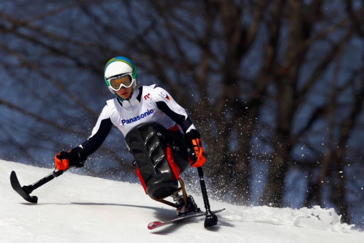 Athlete practicing alpine skiing in a sit-ski.