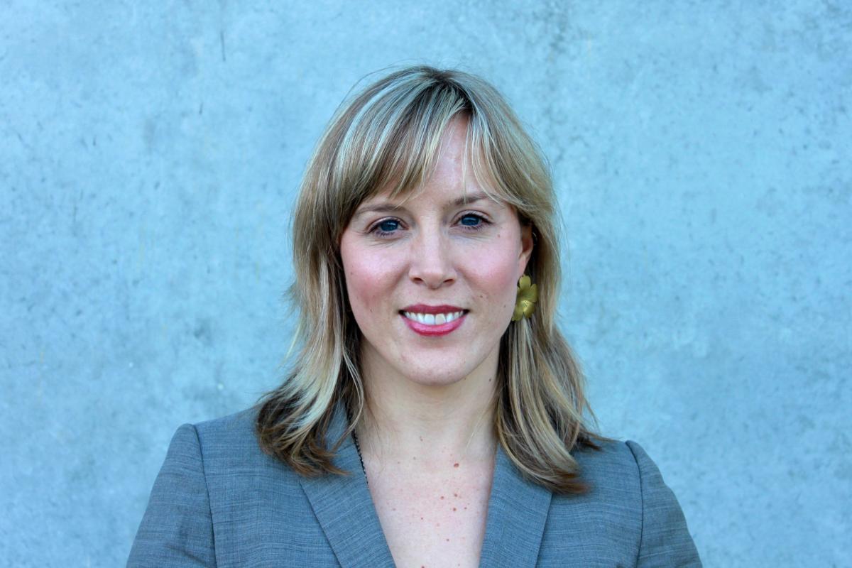 A woman is staring at the camera in a horizontal portrait shot. 