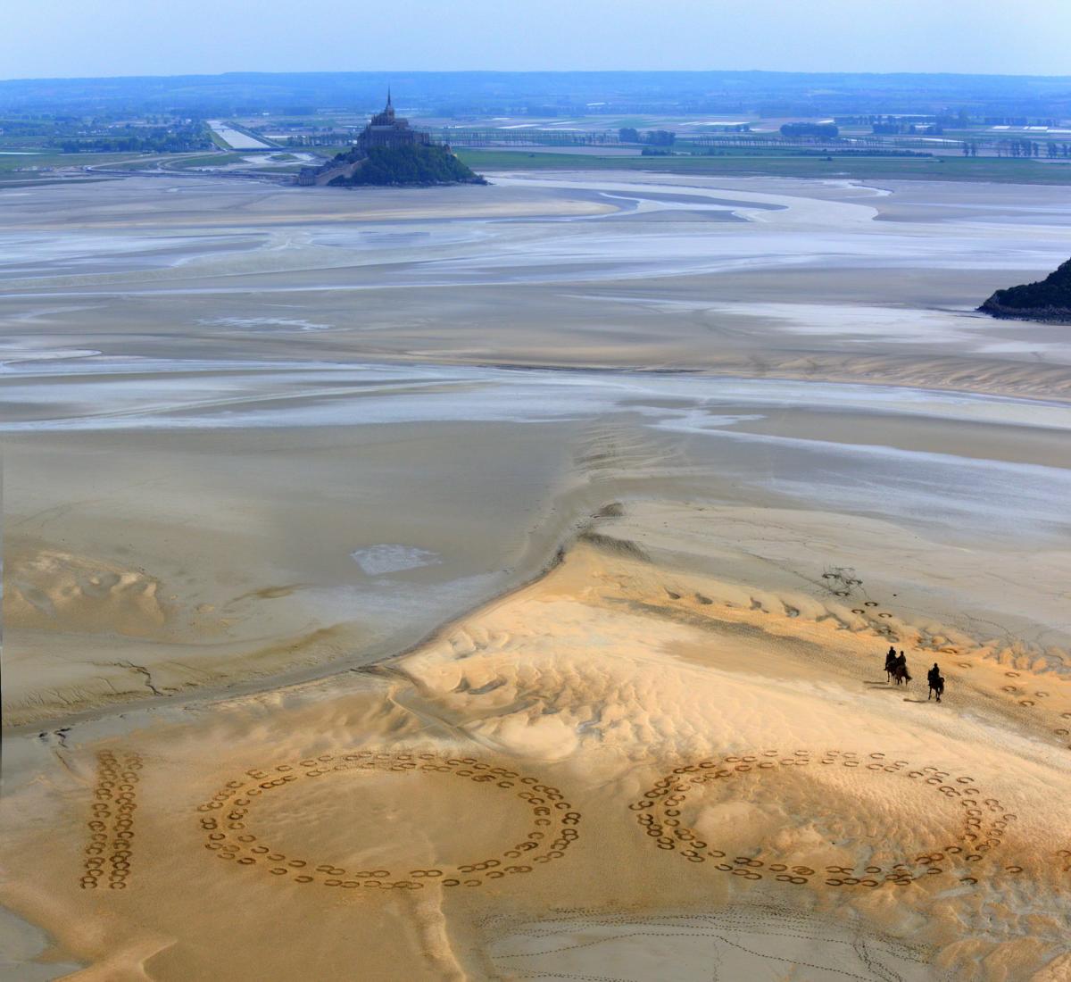 Giant 2.3m by 2.5m horse hoof prints created in the Bay of Mont-Saint-Michel by French artist and sand sculptor Christophe Dumont mark 100 days to the start of the Alltech FEI World Equestrian Games.