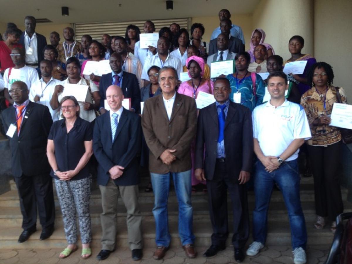 A group of about 40 people pose for a photo after a workshop.