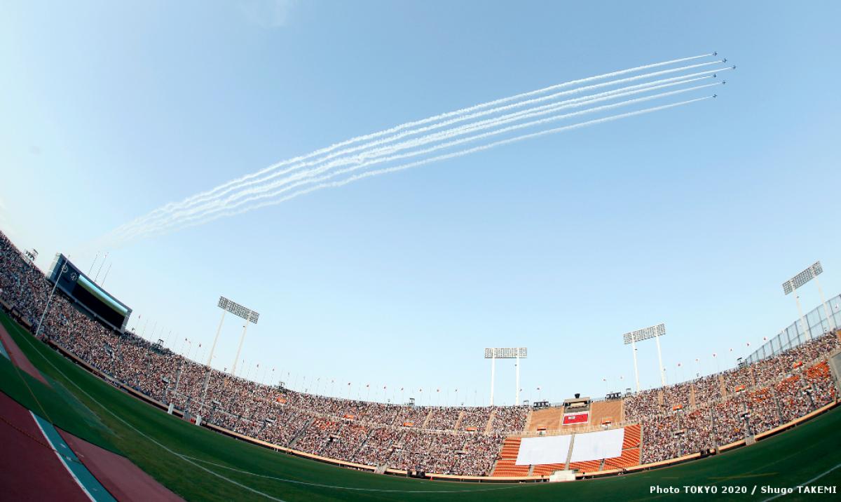 Japan Air Self-Defense Force aerobatic demonstration team ‘Blue Impulse’ in action over the National Stadium and 40,000 fans.