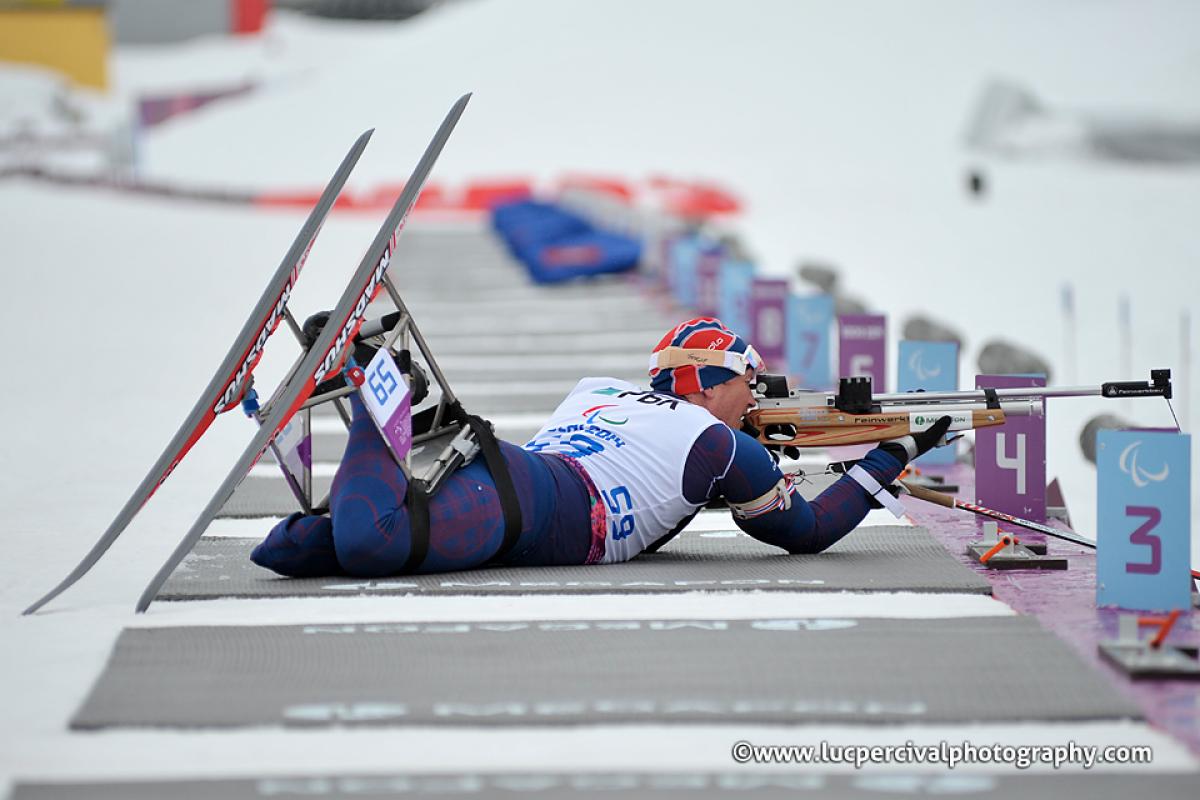 Trygve Steinar Larsen, Norway lines up his shot in biathlon.