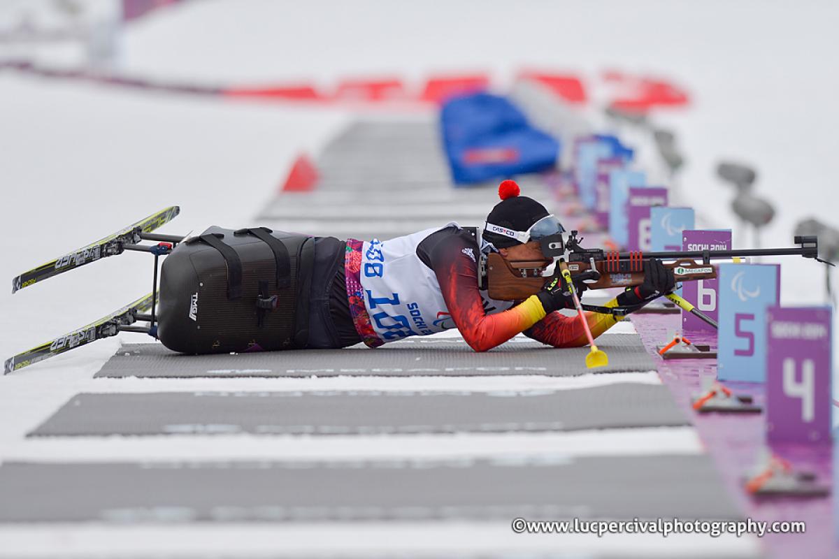 Women in sit ski lies in the shooting range and targets