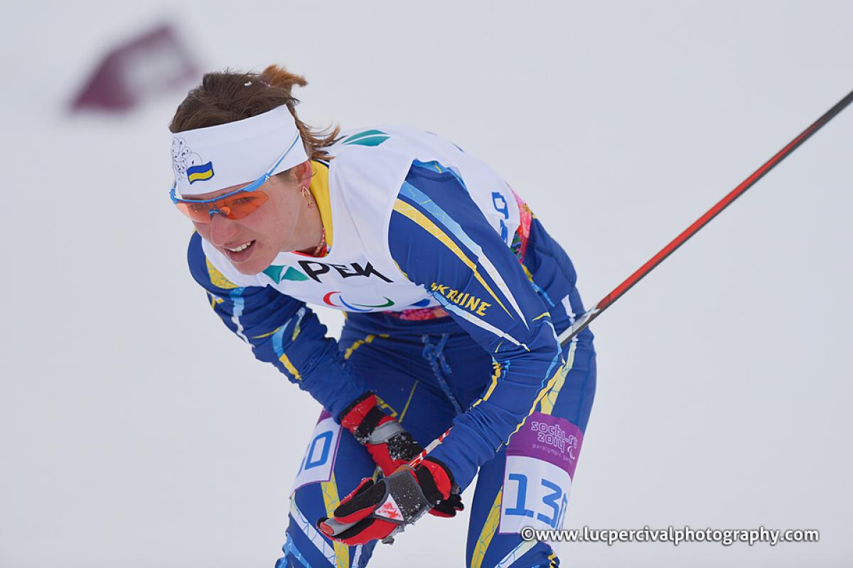 Oleksandra Kononova - Sochi 2014 Winter Paralympic Games Female skier looks exhausted on the snow.