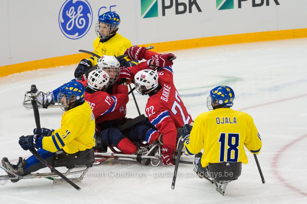 five athletes in sledges on the ice