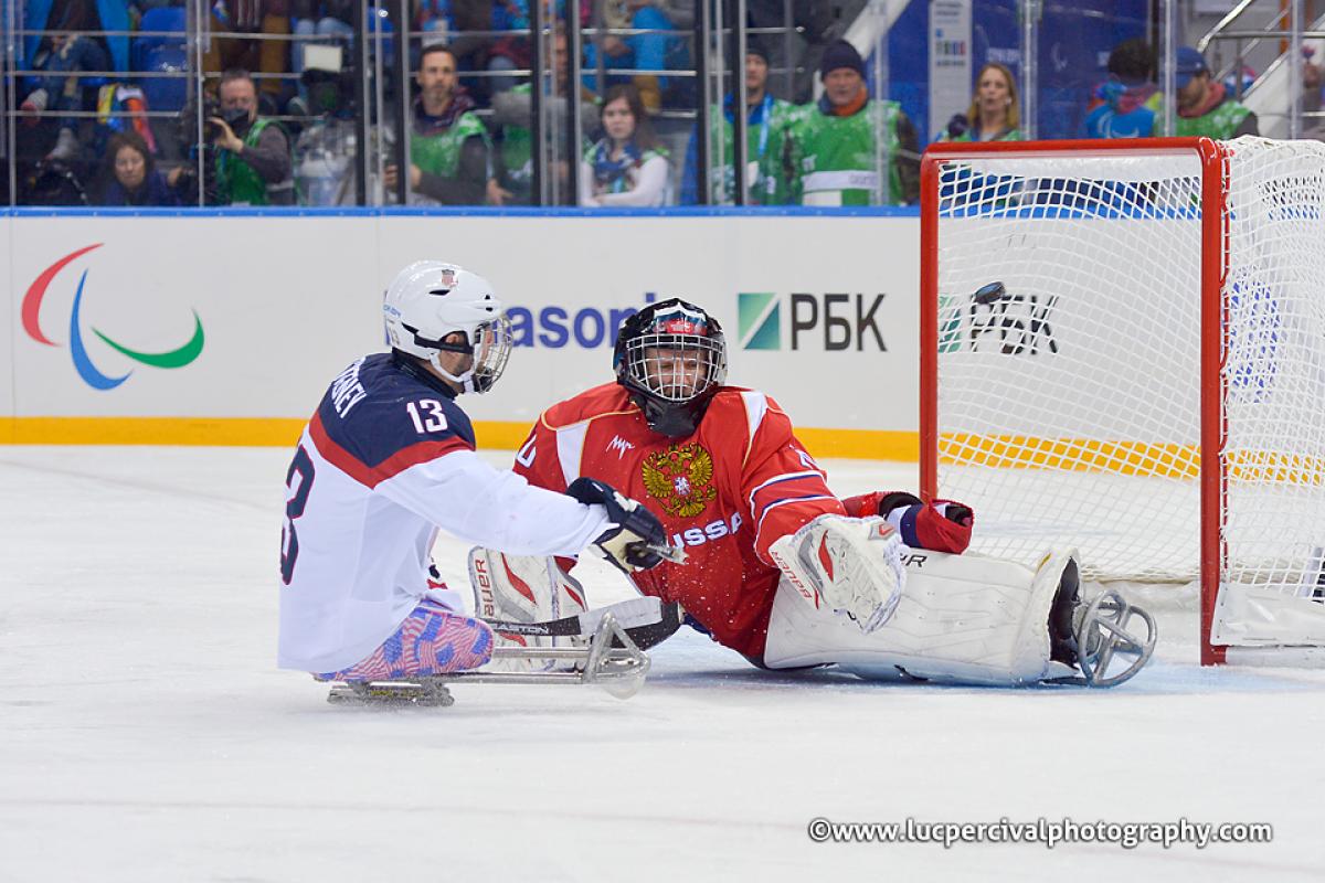 Ice Sledge Hockey - Sochi 2014 Winter Paralympic Games The USA's Josh Sweeney crashes the net during the Sochi 2014 Paralympic Winter Games.