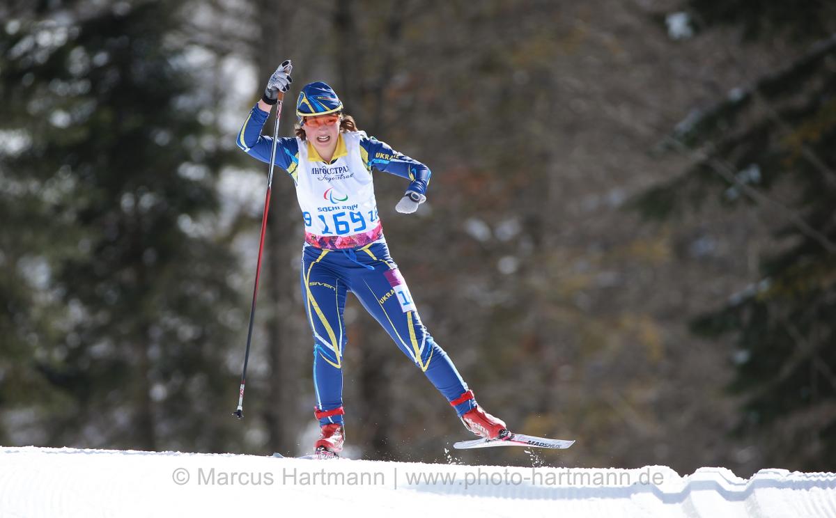 Women on cross country ski in action on the track