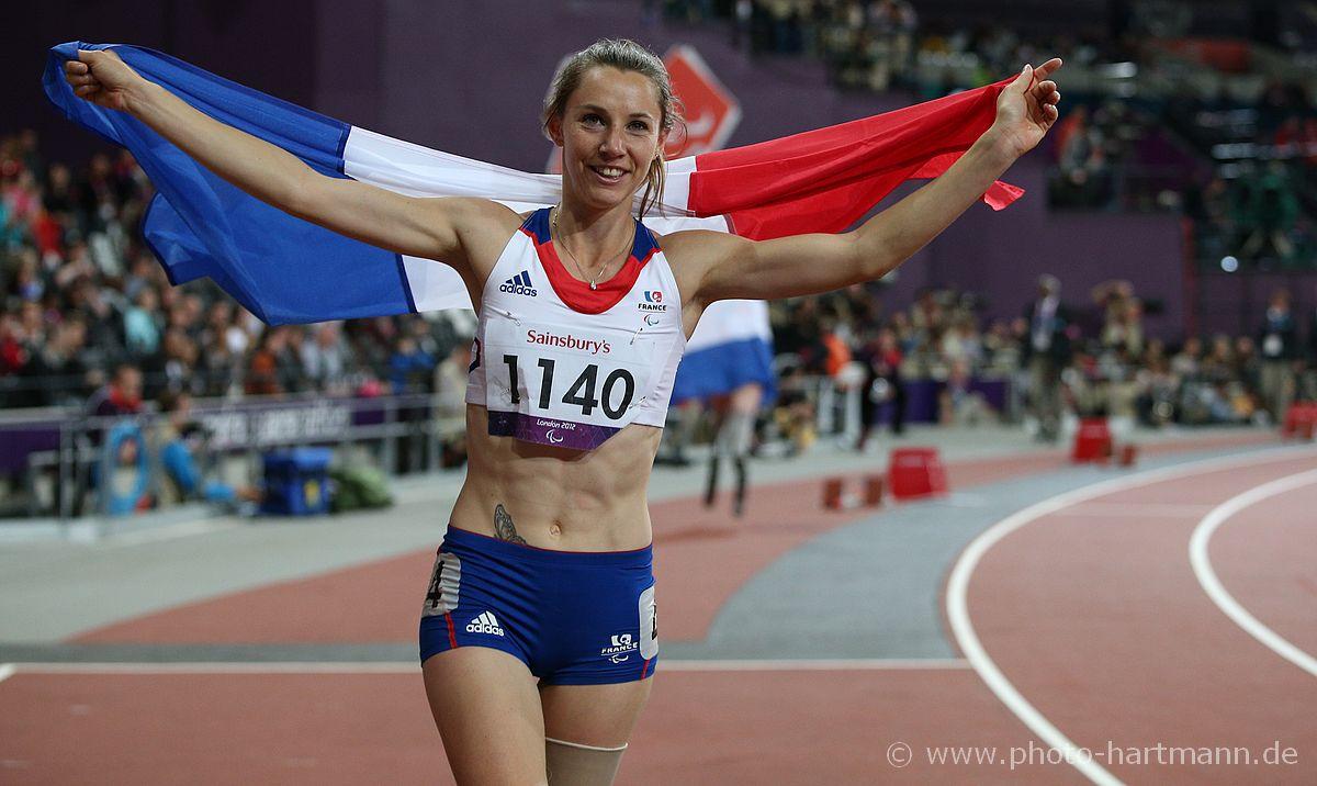 Marie-Amelie Le Fur - Athletics - London 2012 Paralympic Games Woman with French flag celebrating in a stadium